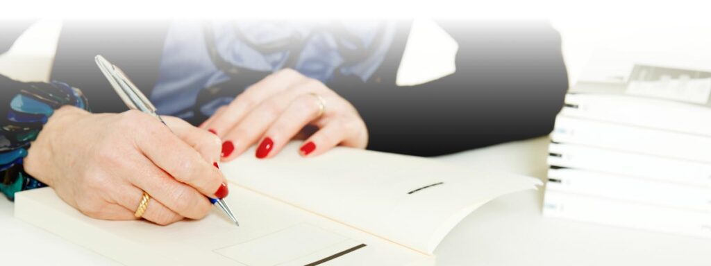 Hodiseh signing a book